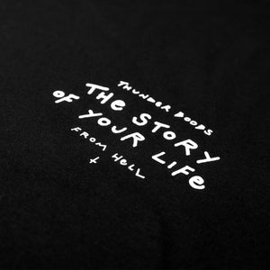 Close up of the white text which says "the story of your life" and "thunder boobs from hell" screen-printed on a black t-shirt